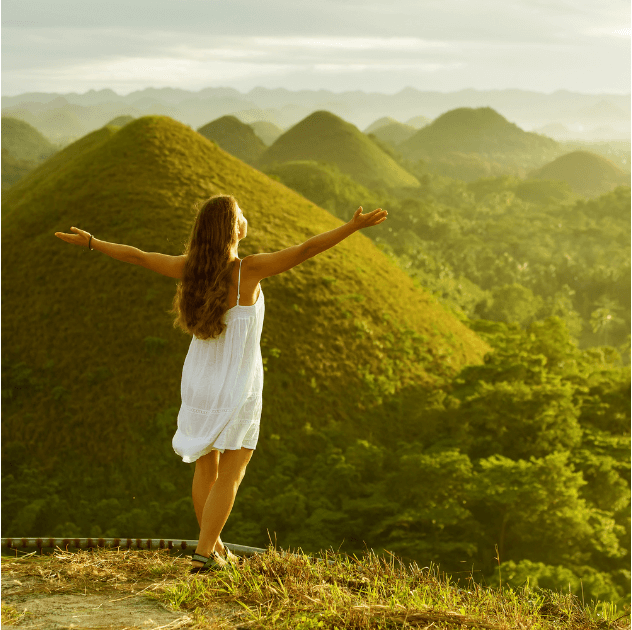 woman on top of chocolate hills